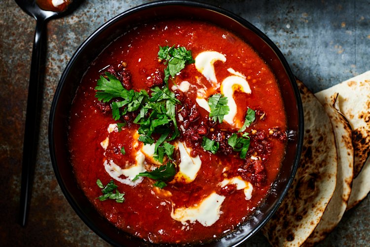 Creamy chipotle-tomato soup with crispy chorizo and toasted seeds.