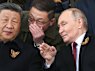 Vladimir Putin speaks to China’s President Xi Jinping during the Victory Day parade in Moscow.