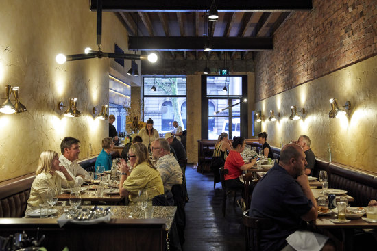 The dining room is a bona fide looker, all brooding leather, original terrazzo sandstone and cedar.