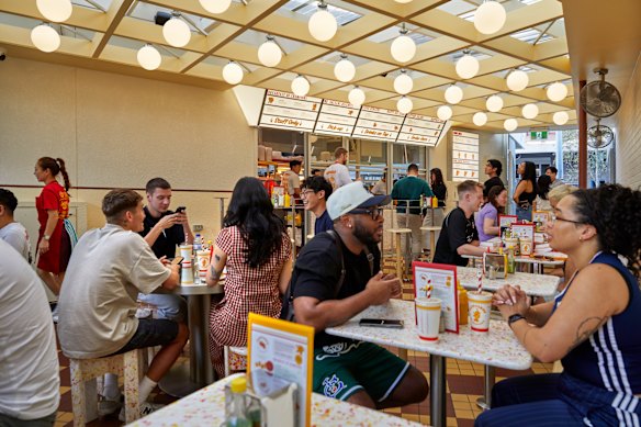 The covered courtyard is reminiscent of a 1950s Californian drive-in or a 1980s McDonald's.