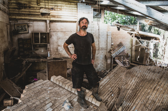 Artist Simon Falomir among the flood-ravaged ruins of his studio in Lismore.