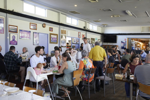 Families pack into the Portuguese dining hall inside the Marrickville Hardcourt Tennis Club.