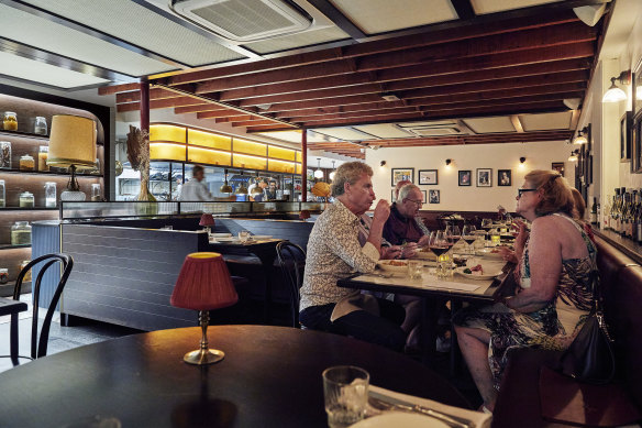 Restaurant Santino’s mood-lit interior and open kitchen.