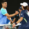 Alcaraz and de Minaur shake hands at the net at the end of their charity match on Rod Laver Arena.
