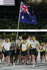 Proud moment: Patty Mills carries the Australian flag at the Olympics in Tokyo last year.