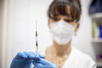 A health worker prepares a dose of Pfizer-BioNTech vaccine.