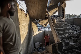 Palestinians inspect their house after it was hit by an Israeli airstrike in Gaza City, on Sunday, August 7.