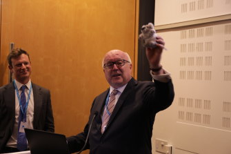 Australia’s High Commissioner to the UK George Brandis brandishes a German-made koala, emphasising that they were not manufactured in China.