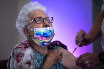 Rachel Gershon, 83, receives a third Pfizer-BioNTech COVID-19 vaccine from a Magen David Adom national emergency service volunteer, at a private nursing home, in Netanya, Israel, Sunday, August 1, 2021.