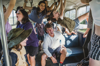 Living School principal John Stewart and students on a school bus used as a learning room.