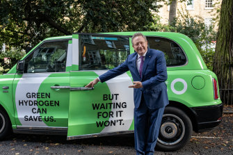 Fortescue boss Andrew âTwiggyâ Forrest with one of his climate campaign cabs in London.