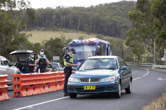 Victoria Police check for permits at a road block at Genoa on the Victorian border last week.