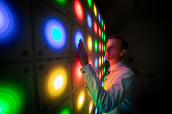 Dr Andrew Gardner using the 64-square light wall, designed to help evaluate concussion symptoms.