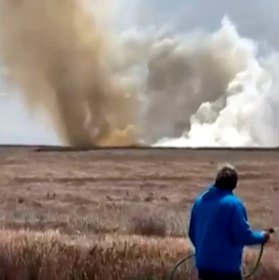 A plume of smoke rises above the plain near Mountain Home Air Force Base.