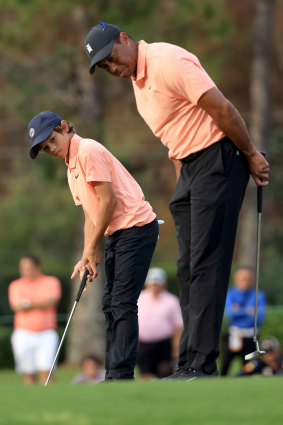 Tiger Woods and his son, Charlie, look over a birdie attempt on the 15th hole. 