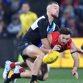 Feel the heat: Robbie Gray lays a crunching tackle on Michael Hibberd.