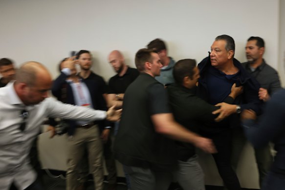 US Senator Alex Padilla, from California, is pushed out of the room as the Homeland Security secretary holds a news conference in Los Angeles.
