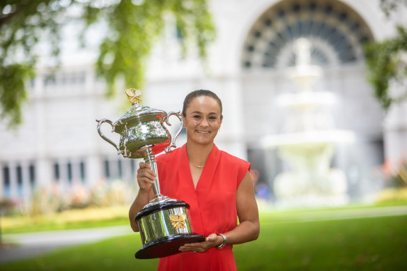 Ash Barty celebrates with the trophy the day after winning the Australian Open.