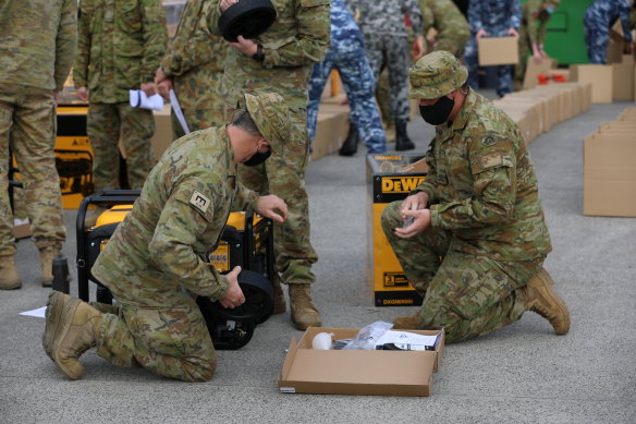 Sappers Mark Weston and Stephen Mullett from the 22nd Engineer Regiment prepare generators to distribute among affected communities, in support to the Victorian Government’s recovery efforts across the state, at the CFA State Logistic Centre in Melbourne.
