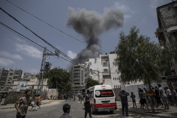 Smoke rises after Israeli air strikes on a residential building in Gaza City on Saturday.