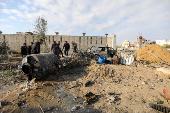 People inspect the damage to their homes following Israeli airstrikes in Rafah on Sunday.