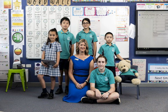 Principal Melanie Macmillan with students at Warwick Farm Public School, which is exceeding expectations in its results.