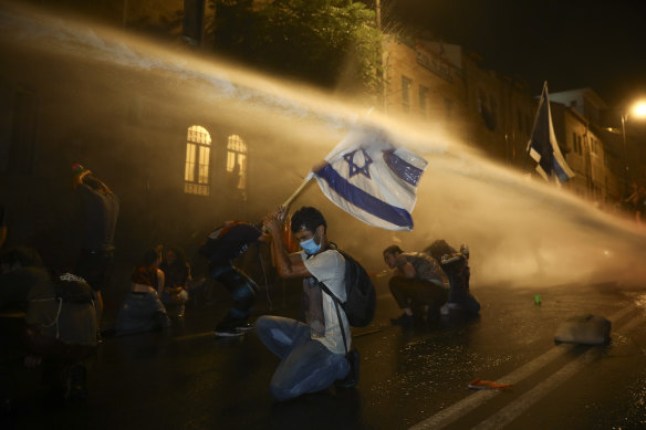 Israeli police use a water canon to disperse people during a protest against Israeli Prime Minister Benjamin Netanyahu in Jerusalem.