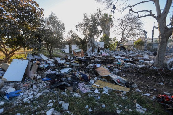 People inspect damage and recover items from their homes following Israeli airstrikes in Rafah, Gaza. 