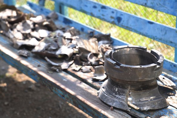 Investigators put fragments on display of what they say were rockets fired from US-supplied HIMARS systems near a destroyed barrack at a prison in Olenivka.