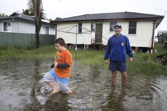 Danny Sondermeyer and son Harrison are nervously eyeing the rising river.