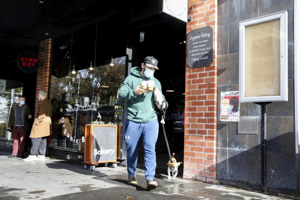 A Sydney resident buys takeaway coffee from a Redfern cafe over the weekend. 