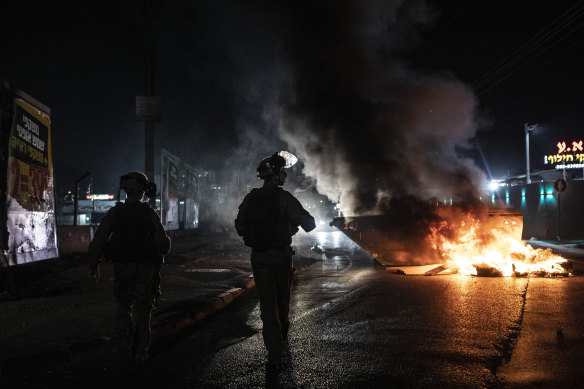 Israeli police patrol during clashes between Arabs, police and Jews, in the mixed town of Lod, central Israel.