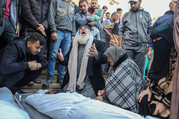 People mourn as they collect the bodies of Palestinians killed in an airstrike in Khan Younis.