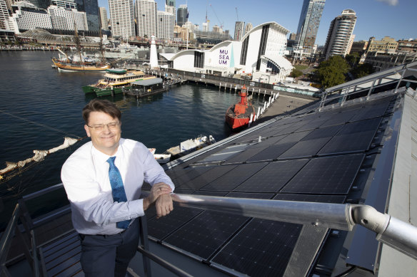 Kevin Sumption, the director and chief executive of the Australian National Maritime Museum, on the roof of the institution's Wharf 7 building where the solar panels have been installed.