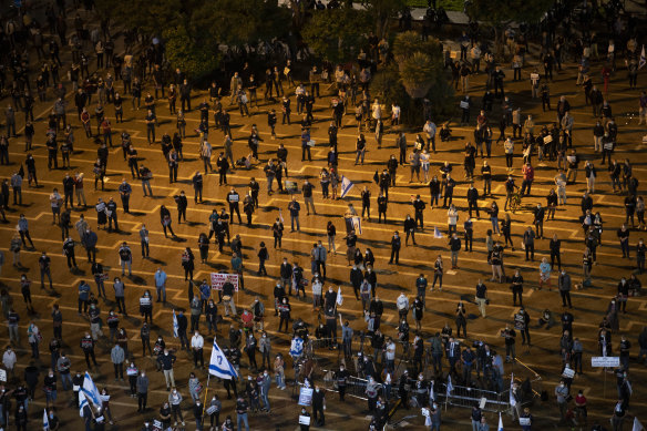 People keep social distancing during a protest against Prime Minister Benjamin Netanyahu in Tel Aviv.