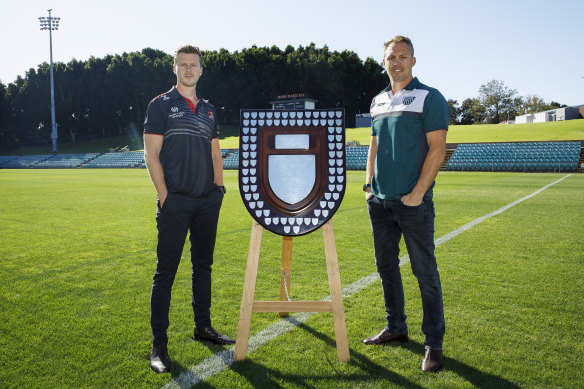 Norths coach Zak Beer and Randwick coach Stephen Hoiles pose with the Shute Shield at Leichhardt Oval.