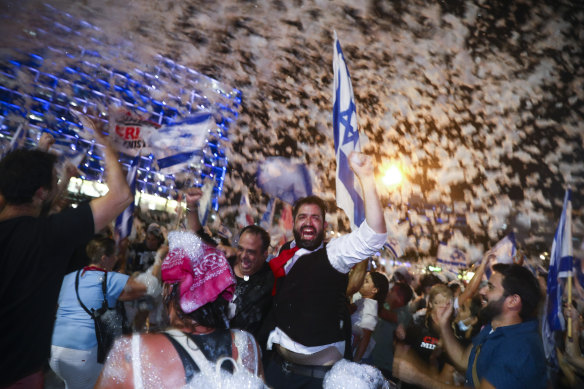 Israelis celebrate the swearing in of the new government in Tel Aviv.