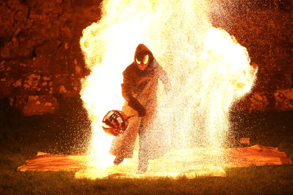 Dark rituals: the hooded-man emerges from the flames at Puca.