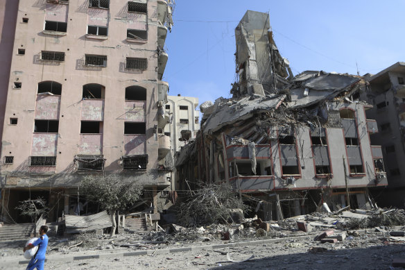 Palestinians leave their homes following Israeli bombardment on Gaza City on Monday.