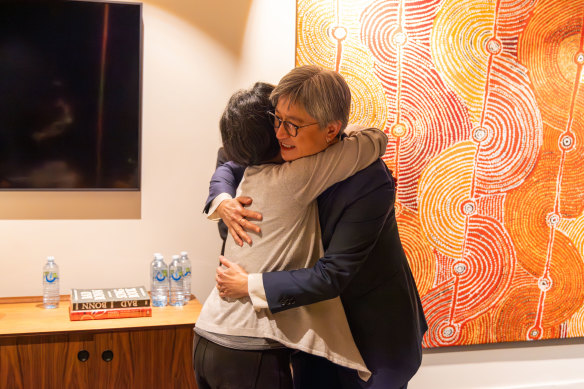 Foreign Minister Penny Wong and Cheng embrace after the journalist returned to Australia.