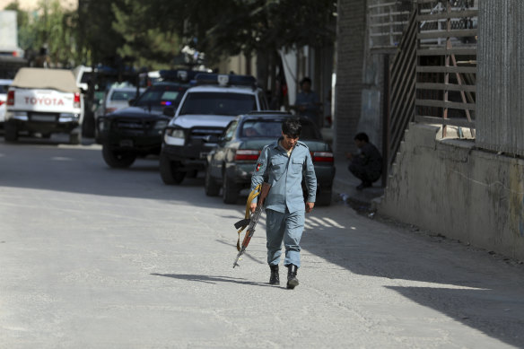 Afghan security personnel arrive at the scene of the fatal shooting of media chief Dawa Khan Menapal.