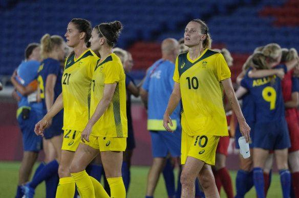 Laura Brock, Steph Catley and Emily van Egmond depart the field after Australia’s loss to Sweden. 