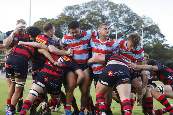 Blake Schoupp (middle with tape on ear) helping the Southern Districts scrum blast through Norths in 2022.