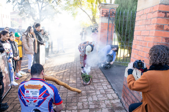 A smoking ceremony is held outside the courthouse before the inquest begins.