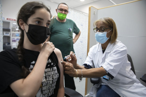 An Israeli youth receives a Pfizer-BioNTech COVID-19 vaccine in the central Israeli city of Rishon LeZion.