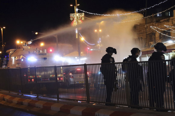 Israeli police use a water cannon to disperse Palestinian protesters from the area near the Damascus Gate in the Old City of Jerusalem.