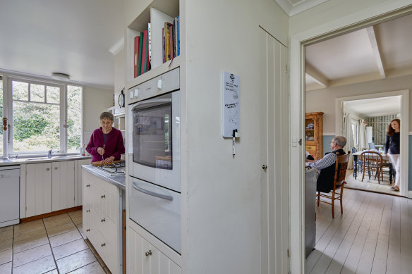Robin Mosman, at left, in her apartment’s kitchen. The door into the kitchen of daughter Zoe’s family is the junction between the two homes.