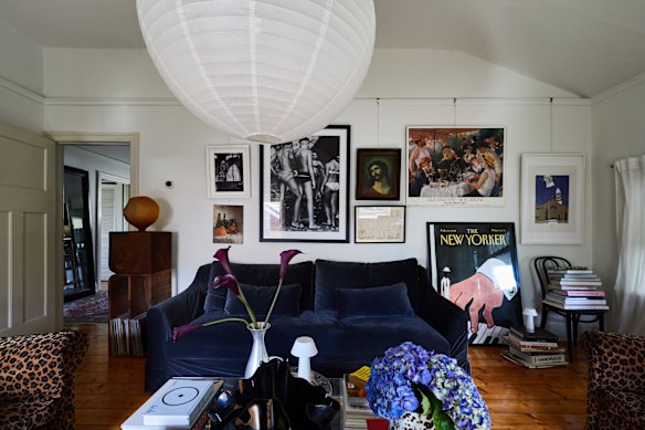 Williams and Roux have hung their combined art collection gallery-style in the lounge room. “We’re drawn to pieces that speak to our creative sides and the way we approach our respective practices,” says Roux. Adds Williams, “The blue velvet sofa was bought at IKEA years ago.”