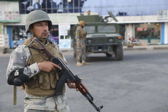Afghan soldiers stand guard near a polling station in Kabul.