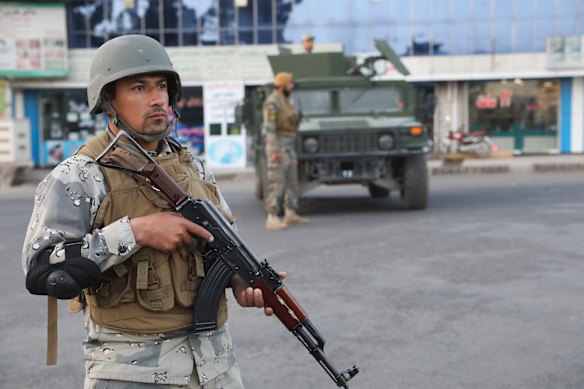 Afghan soldiers stand guard near a polling station in Kabul.